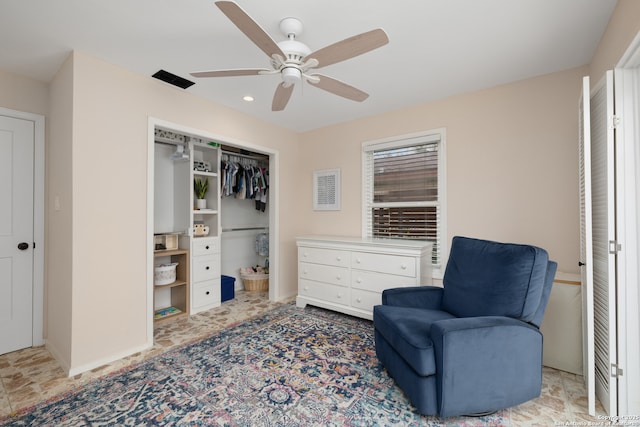 living area featuring a ceiling fan