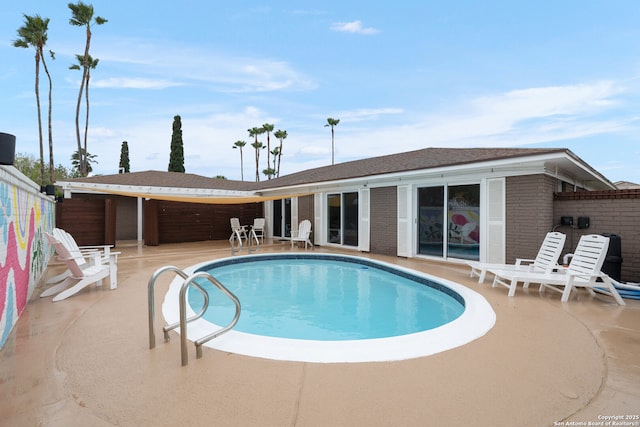 view of swimming pool with a patio area, a fenced in pool, and fence