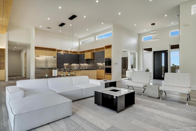 living area featuring recessed lighting and a towering ceiling