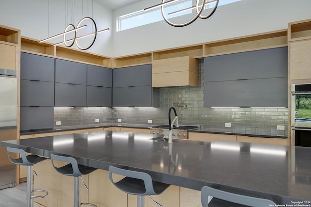 kitchen with tasteful backsplash, a breakfast bar, appliances with stainless steel finishes, modern cabinets, and open shelves