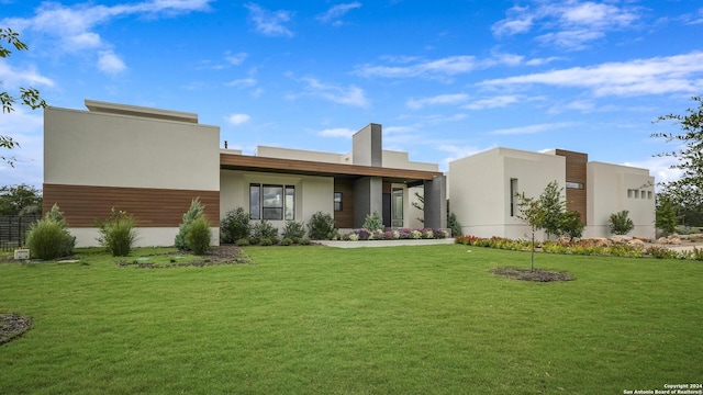 view of front of home featuring stucco siding and a front lawn