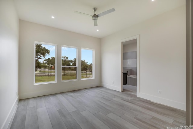 spare room with recessed lighting, a ceiling fan, light wood-type flooring, and baseboards