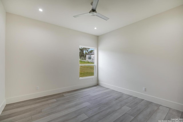 empty room featuring ceiling fan, baseboards, wood finished floors, and recessed lighting