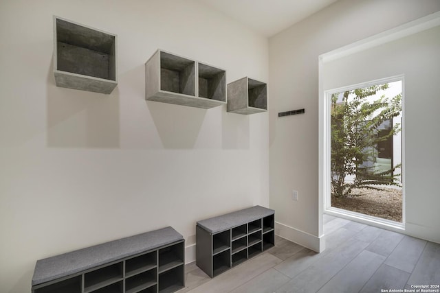 mudroom featuring baseboards and wood finished floors