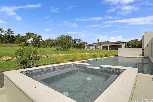 outdoor pool with an in ground hot tub and a lawn