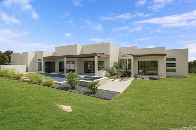 rear view of house with stucco siding, a patio, a yard, an outdoor pool, and an in ground hot tub