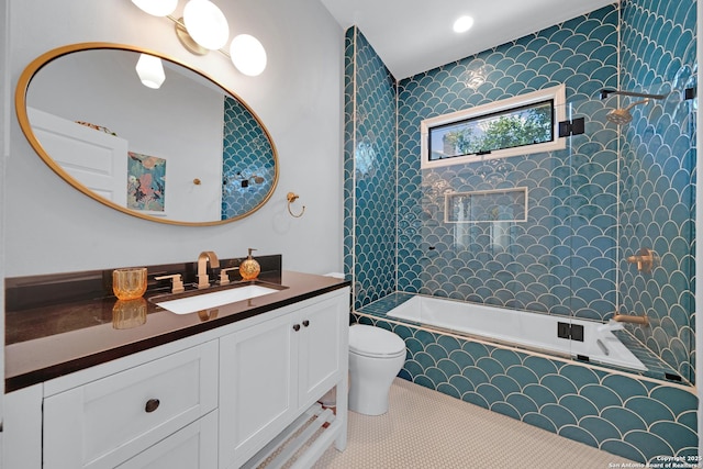 full bath with tile patterned flooring, toilet, vanity, and tiled shower / bath combo