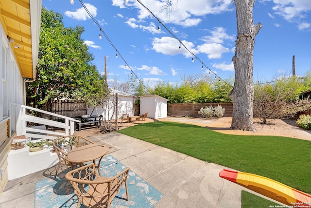 view of patio / terrace featuring an outbuilding, a storage shed, and a fenced backyard