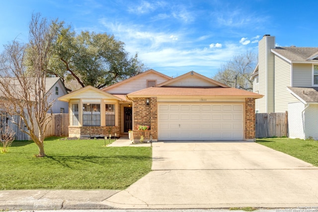 view of front of property featuring brick siding, fence, a front yard, driveway, and an attached garage