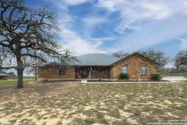 single story home with metal roof and covered porch