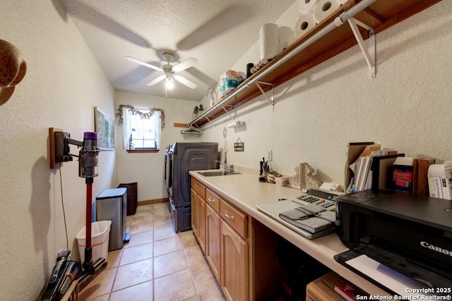 clothes washing area with ceiling fan, laundry area, light tile patterned flooring, washer and dryer, and a sink