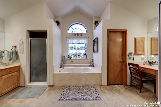 full bath with vanity, lofted ceiling, a garden tub, and a shower stall