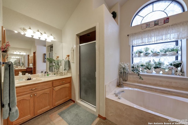 bathroom featuring vanity, lofted ceiling, a stall shower, tile patterned flooring, and a garden tub