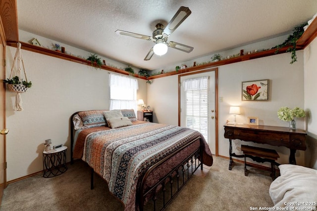 bedroom featuring baseboards, carpet floors, a textured ceiling, and a ceiling fan