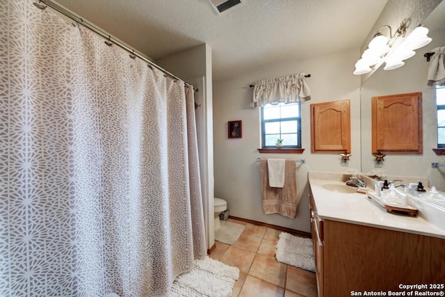 full bath featuring visible vents, toilet, vanity, tile patterned floors, and a textured ceiling