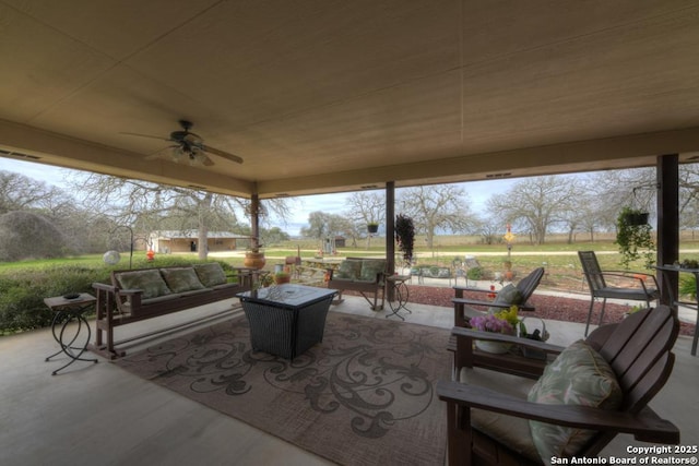 view of patio featuring an outdoor living space, visible vents, and ceiling fan