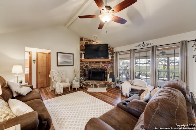 living room with a fireplace, lofted ceiling with beams, wood finished floors, and a ceiling fan