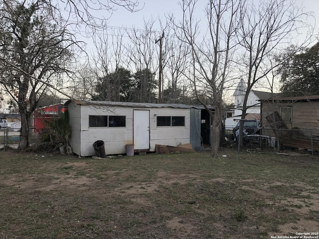 view of outbuilding with fence