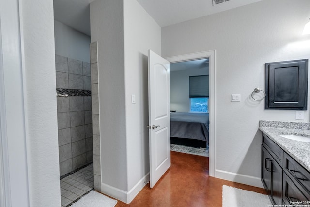 full bath with vanity, connected bathroom, baseboards, and walk in shower