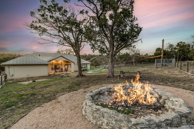 view of yard with a fire pit and fence