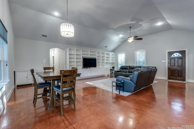 dining space featuring visible vents, ceiling fan with notable chandelier, finished concrete floors, arched walkways, and baseboards