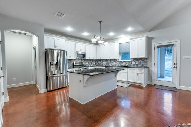 kitchen with finished concrete flooring, visible vents, arched walkways, appliances with stainless steel finishes, and white cabinetry