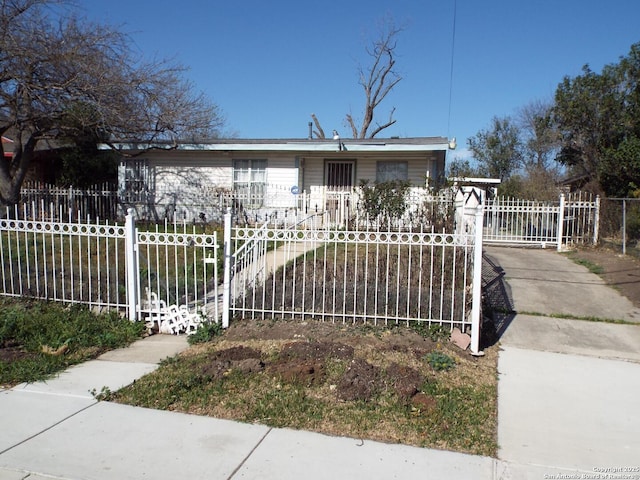 view of front facade with a fenced front yard and a gate