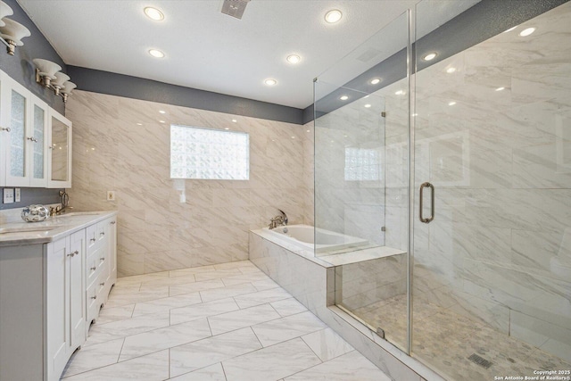 full bath featuring visible vents, double vanity, a stall shower, a garden tub, and marble finish floor