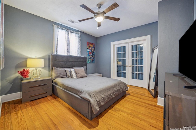 bedroom featuring visible vents, baseboards, ceiling fan, light wood-style flooring, and french doors