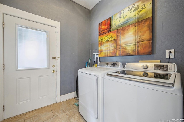 laundry room with laundry area, light tile patterned floors, and independent washer and dryer