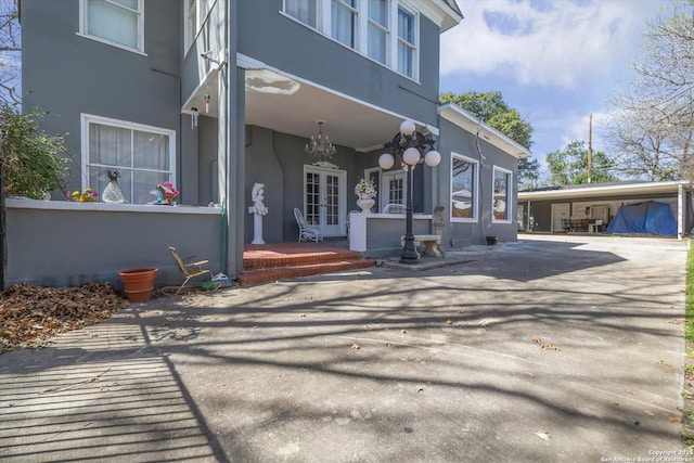 exterior space with french doors and a carport