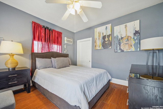 bedroom with a ceiling fan, wood finished floors, and baseboards