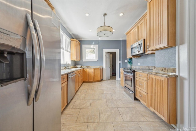 kitchen with pendant lighting, a sink, recessed lighting, stainless steel appliances, and light stone countertops