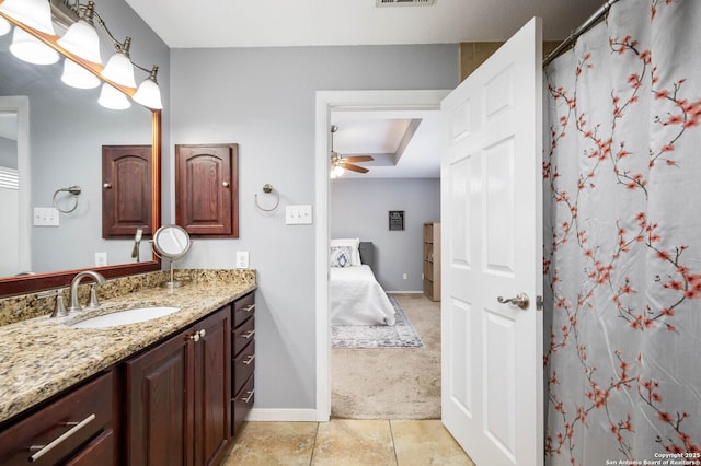 ensuite bathroom with vanity, a ceiling fan, baseboards, tile patterned flooring, and connected bathroom