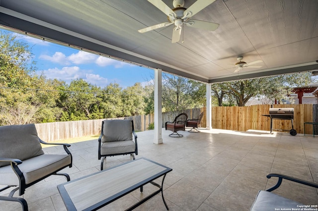 view of patio featuring a grill, a fenced backyard, and a ceiling fan