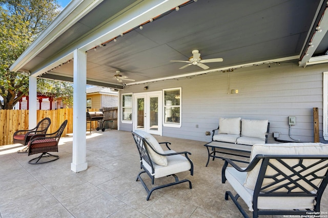 view of patio / terrace featuring outdoor lounge area, french doors, fence, and ceiling fan