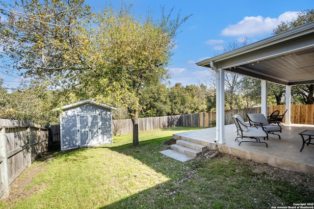 view of yard with a patio area, a fenced backyard, a storage unit, and an outdoor structure