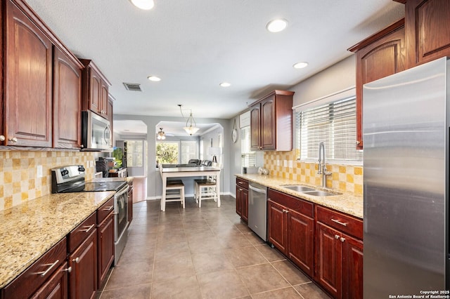 kitchen featuring a healthy amount of sunlight, visible vents, appliances with stainless steel finishes, and a sink