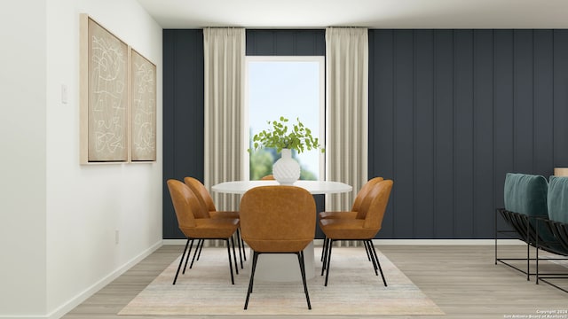 dining area featuring light wood-type flooring and baseboards