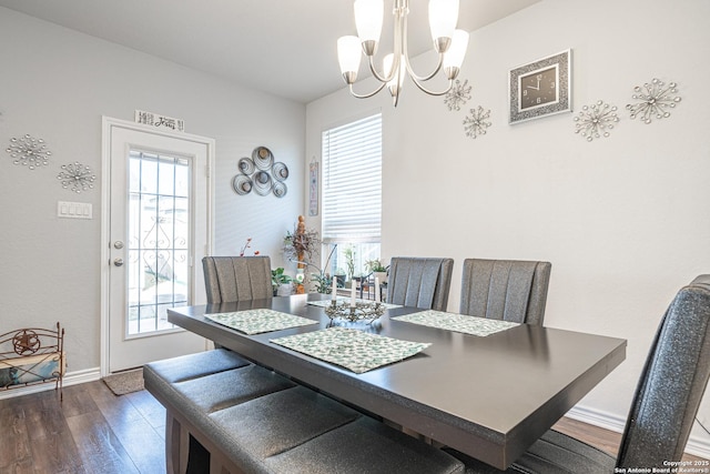 dining area with a chandelier, baseboards, a healthy amount of sunlight, and wood finished floors