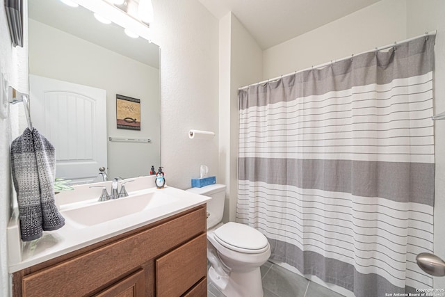 bathroom with tile patterned floors, a shower with curtain, toilet, and vanity