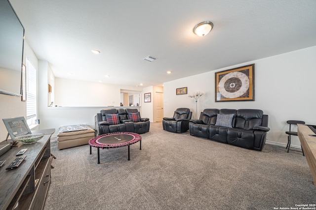 carpeted living room with recessed lighting and visible vents