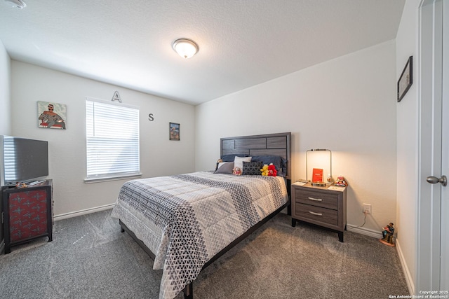 bedroom with baseboards and dark carpet