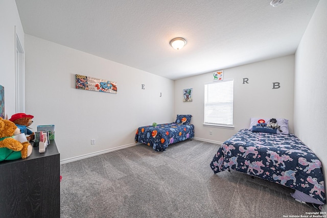 bedroom featuring baseboards, carpet floors, and a textured ceiling