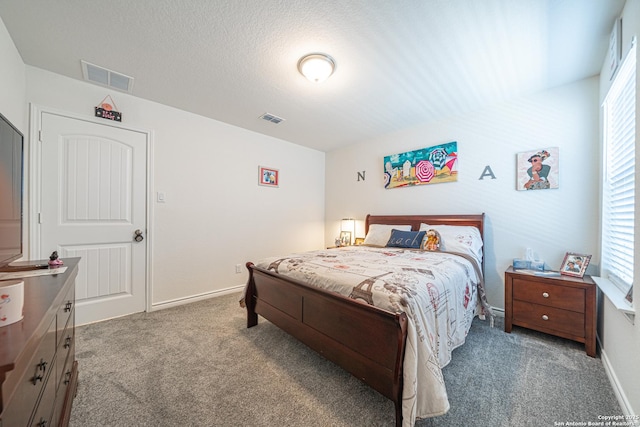 bedroom with multiple windows, baseboards, and visible vents