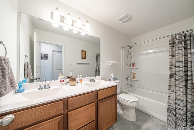 bathroom featuring visible vents, double vanity, a sink, tile patterned floors, and toilet