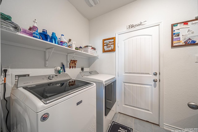 clothes washing area with visible vents, independent washer and dryer, light tile patterned flooring, and laundry area