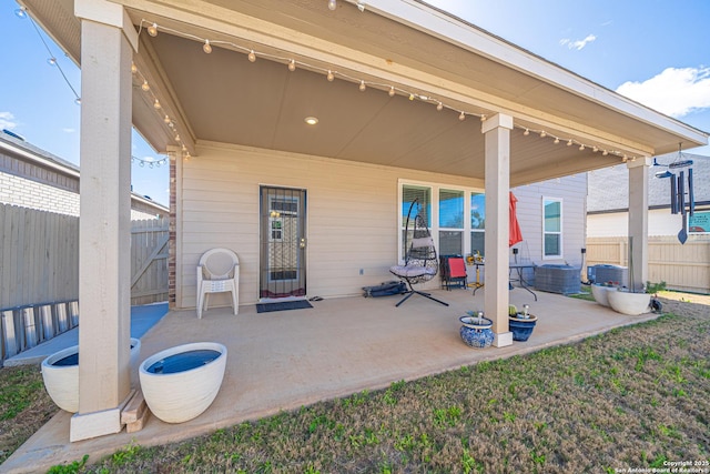 view of patio with cooling unit and fence