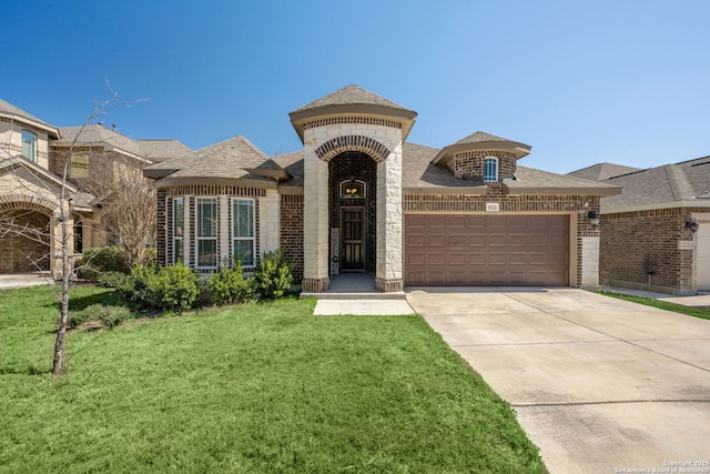 french provincial home featuring a front yard, driveway, a shingled roof, a garage, and brick siding