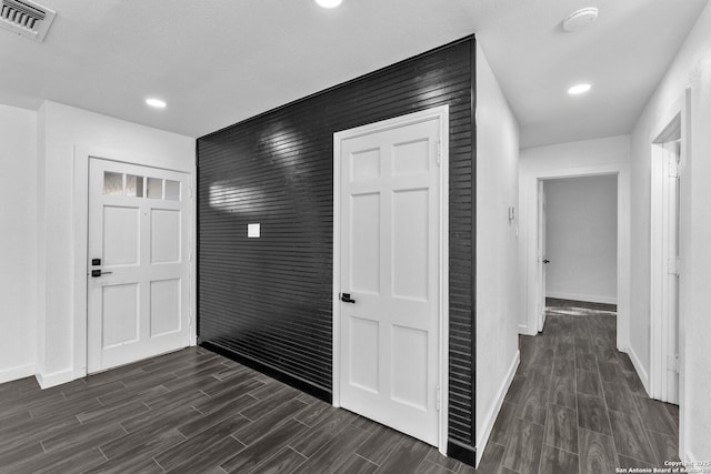 corridor with recessed lighting, baseboards, visible vents, and wood finish floors